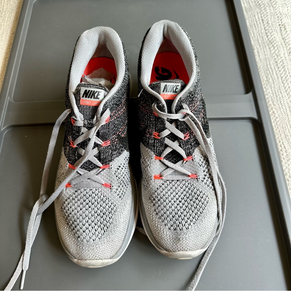 Nike Grey and Black Flyknit Running Shoes with Orange Accents